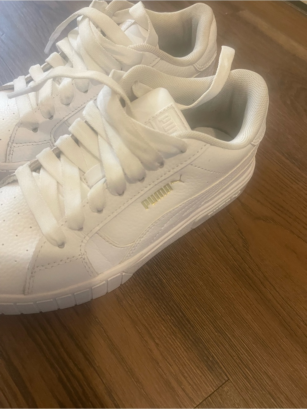 Puma women’s White Sneakers with Gold Logo Accent